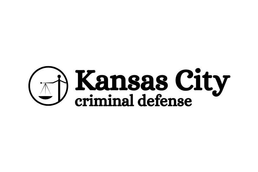 The logo for a Kansas City criminal defense law firm. On the left is a circular black icon showing a stylized figure holding the scales of justice. To the right, the text reads "Kansas City" in a large, bold, black serif font, with the words "criminal defense" written underneath in a smaller, lowercase, sans-serif font. The entire logo is set against a dark green background.